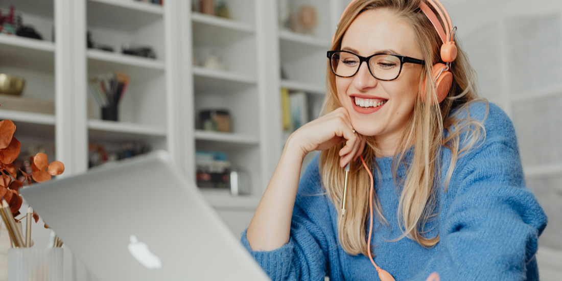 A woman wearing eyeglasses looking at laptop
