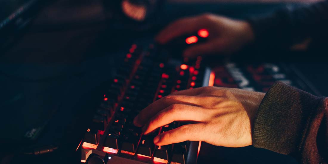 Hands typing on computer keyboard