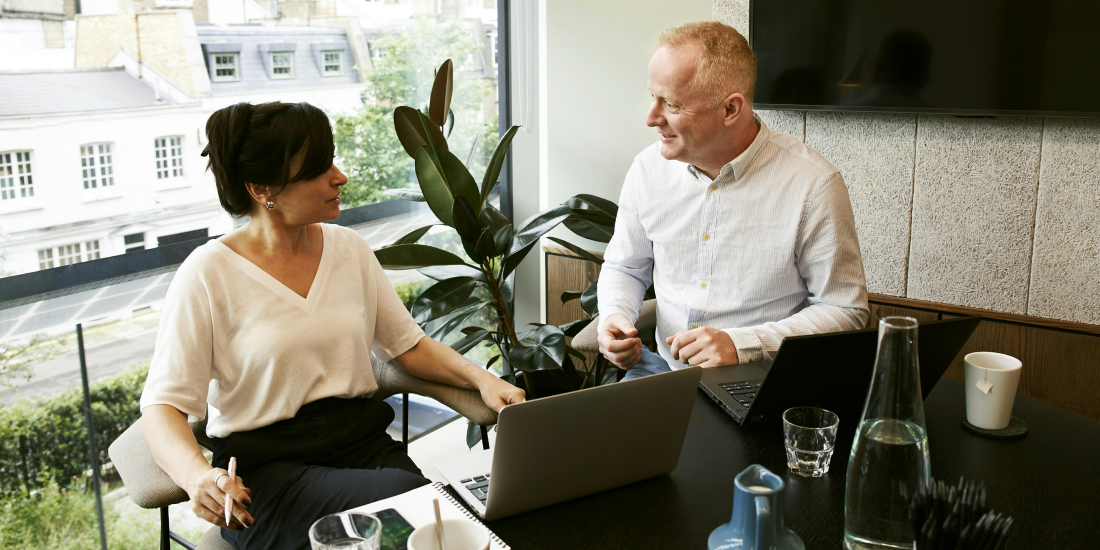 Two letting agents talking in office