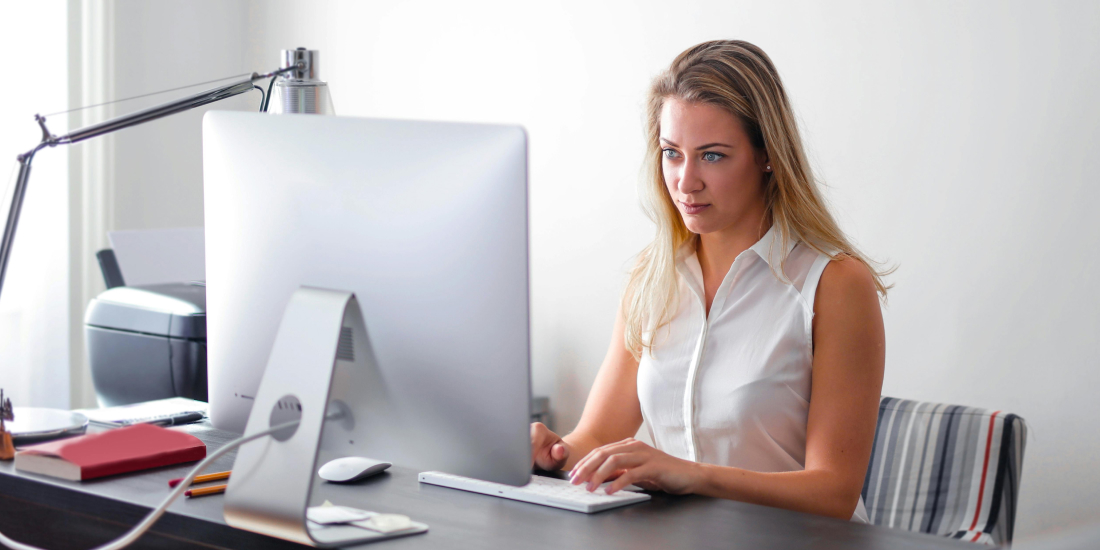 Female estate agent working on computer
