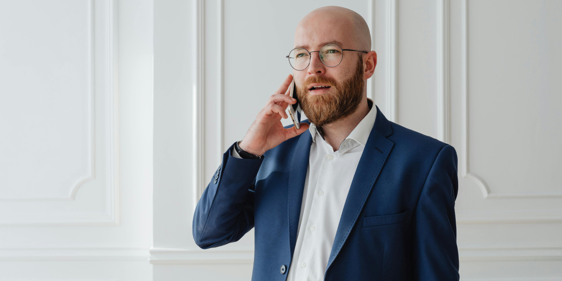Man on the phone in a blue suit