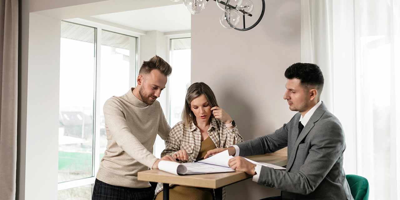 Letting agent speaking to a couple during house viewing