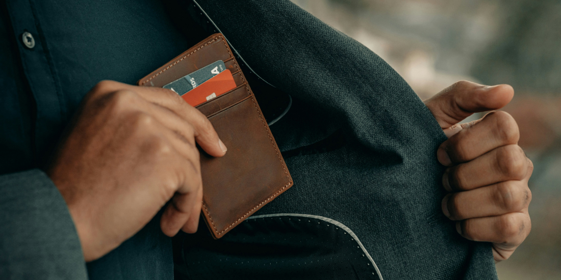 Man putting wallet in his jacket