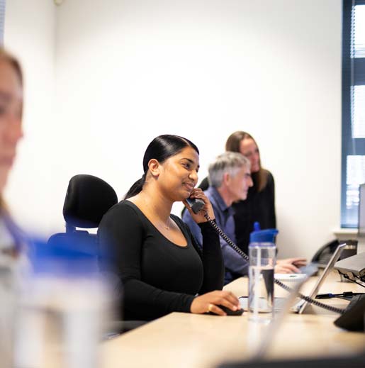 Staff member smiling whilst on telephone call