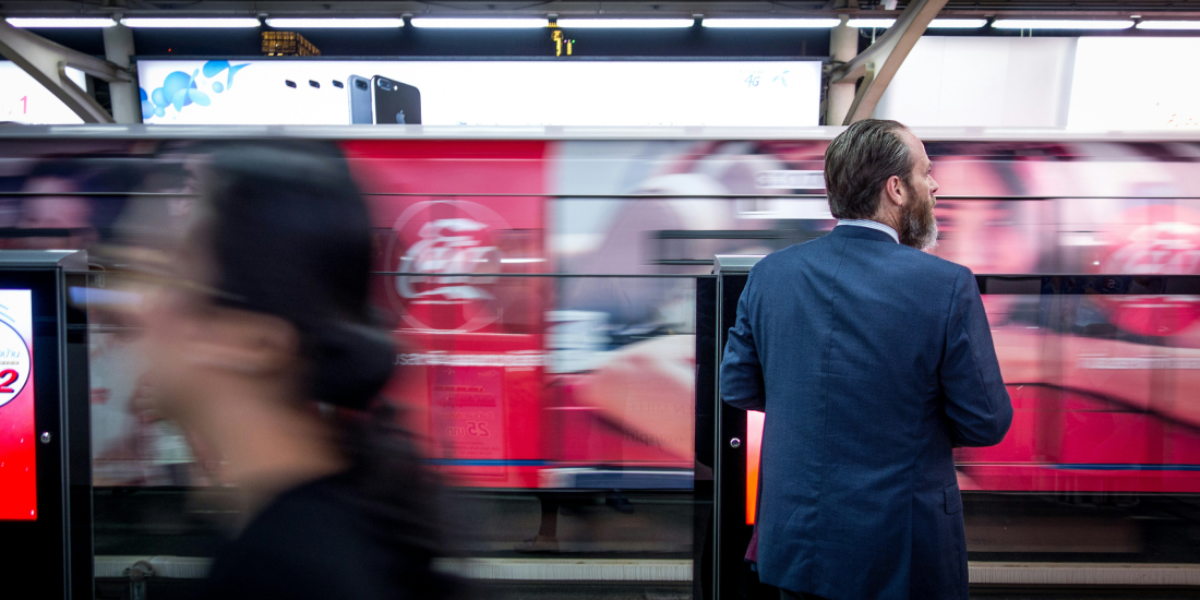 Man in suit waiting for train