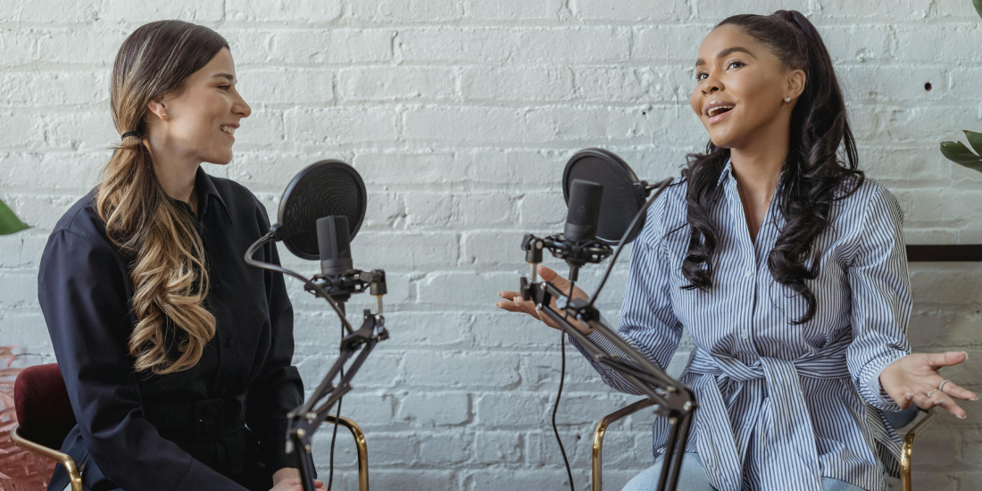 Two female professionals hosting a podcast webinar